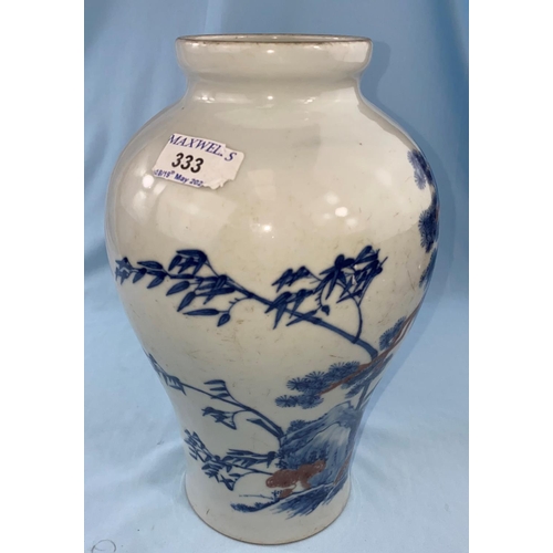 333 - A Chinese blue and white inverted baluster vase depicting trees on landscape with red highlights bea... 