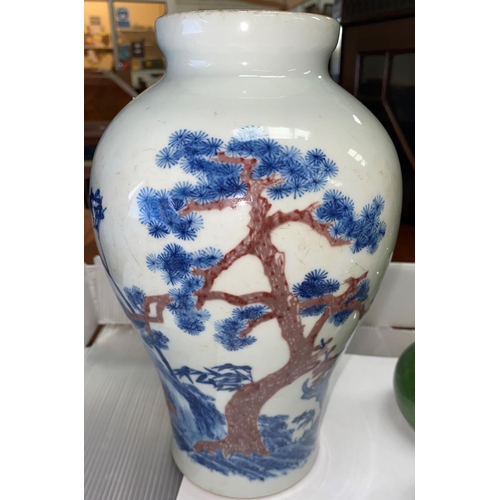 333 - A Chinese blue and white inverted baluster vase depicting trees on landscape with red highlights bea... 