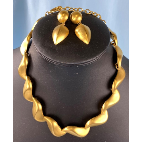 446 - A Givenchy gilt metal necklace and earring set of linked like forms, necklace length 49cm