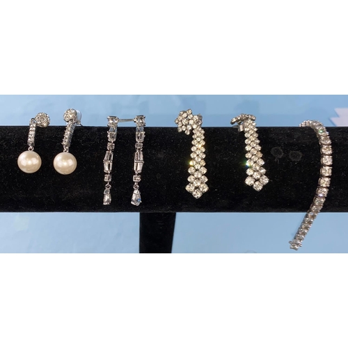 455 - A white metal and clear stone bracelet stamped 925; a diamante necklace and 5 pairs of similar earri... 