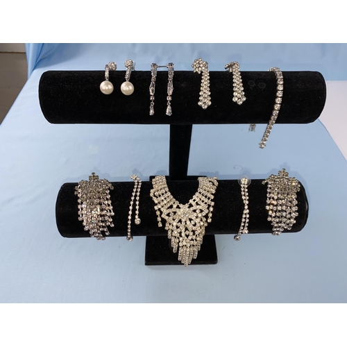 455 - A white metal and clear stone bracelet stamped 925; a diamante necklace and 5 pairs of similar earri... 