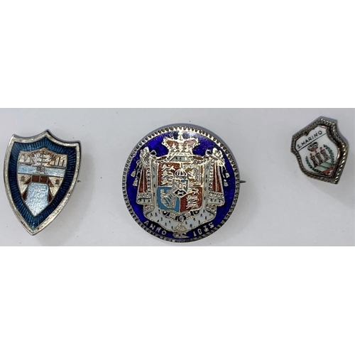 487 - A white metal enamel shield shaped badge, an enamelled Georgian 1835 coin brooch and another badge