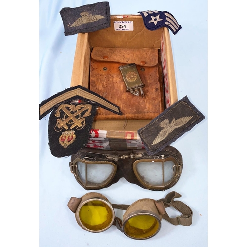 224 - A pair of aluminum framed goggles with yellow tint lenses, another pair, a trench art lighter etc