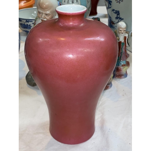 337 - A Chinese pink glaze inverted baluster vase with wide shoulders and small floral rim with character ...