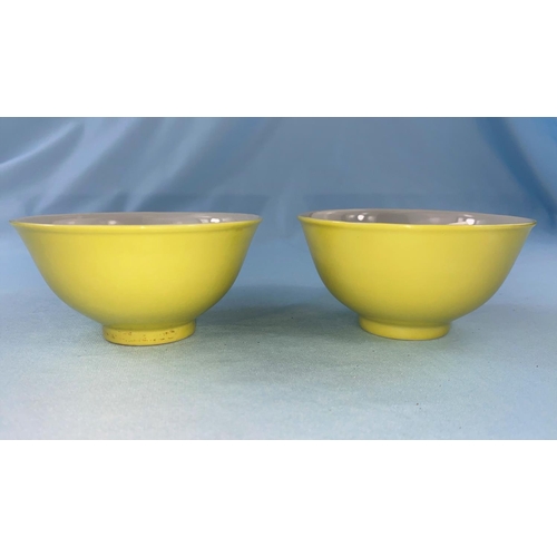 338 - A pair of Chinese yellow glaze tea bowls with four character mark to the bases (1 a.f. - hairline cr... 