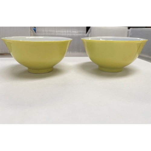 338 - A pair of Chinese yellow glaze tea bowls with four character mark to the bases (1 a.f. - hairline cr... 