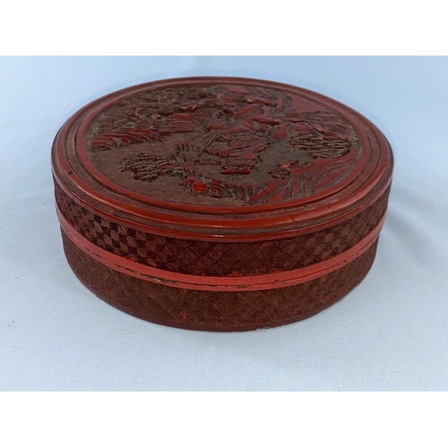 343 - A Chinese cinnabar coloured lacquered circular box with relief mountain scene to top diameter 15.5cm