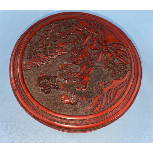 343 - A Chinese cinnabar coloured lacquered circular box with relief mountain scene to top diameter 15.5cm