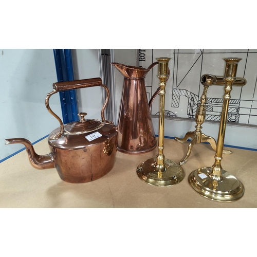 117 - An oval 19th century copper kettle; a pair of slender column candlesticks; a tapering brass jug and ... 