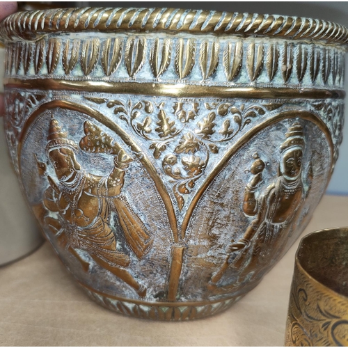 125 - An Indian brass jardinière with paneled decoration in relief of Hindu gods. H: 16cm, Diameter: 20cm;... 