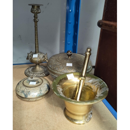 128 - A brass pestle and mortar, brass candle sticks of fox heads, a Middle Eastern lidded pot and another