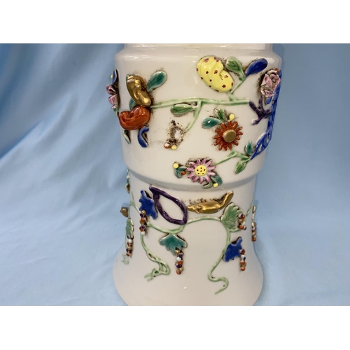 334 - A large Chinese beaker vase with areas of relief and raised decoration on a white background having ... 