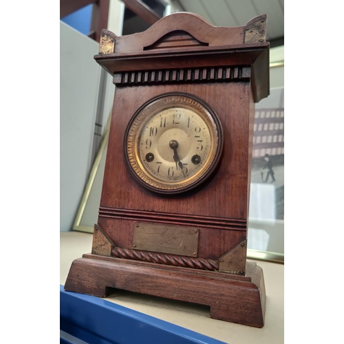 28 - An Edwardian stained wood cased mantel clock