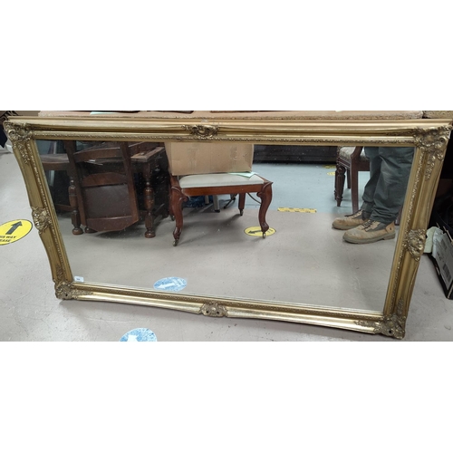 560 - A large gilt framed rectangular mirror, H: 74 x L:135cm