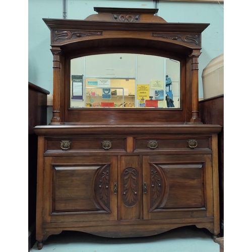 564 - An Edwardian Art Nouveau carved walnut sideboard the mirror back with full turned side pillars, the ... 