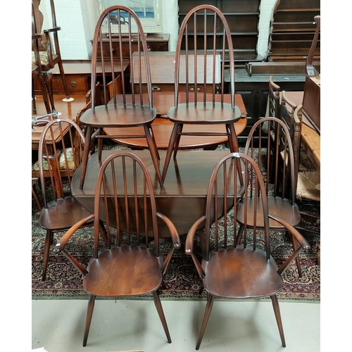 605 - An Ercol dark oak dining suite comprising drop leaf table and 6 (4 + 2) chairs