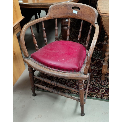 611a - A smoker's/captain's oak armchair with bow stick back and red leather effect cushion