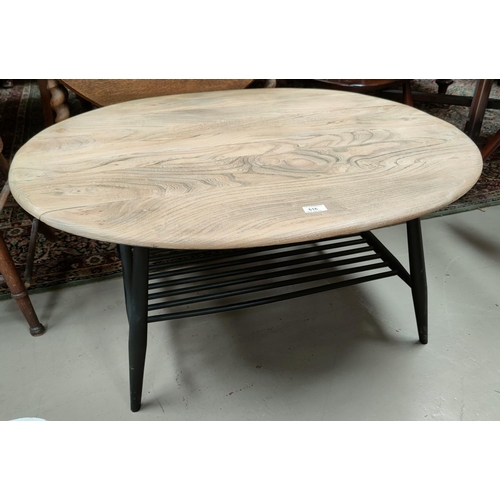 616 - An Ercol coffee table with lightwood oval top, painted legs and undershelf