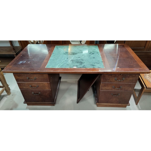 653 - A period style executive desk with twin pedestals, in burr walnut and mahogany, inset green marble t... 