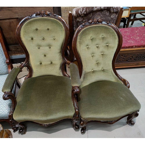 655 - A pair of Victorian walnut ladies and gents spoon back chairs with carved crests, knurled feet and c... 