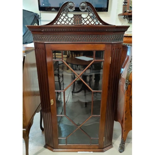 664 - A 19th century mahogany Chippendale style corner cabinet with pierced and blind fret decoration, enc... 