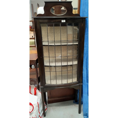 708 - A late 19th/early 20th century ebonised leaded glass door display cabinet, on tapering legs, with sm... 