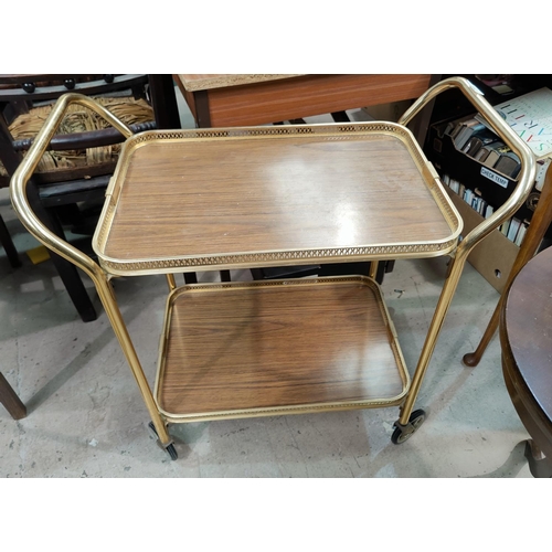 711 - A vintage gilt drinks trolley, a demi-lune table and circular occasional table