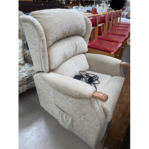 692 - An electric reclining armchair in fawn