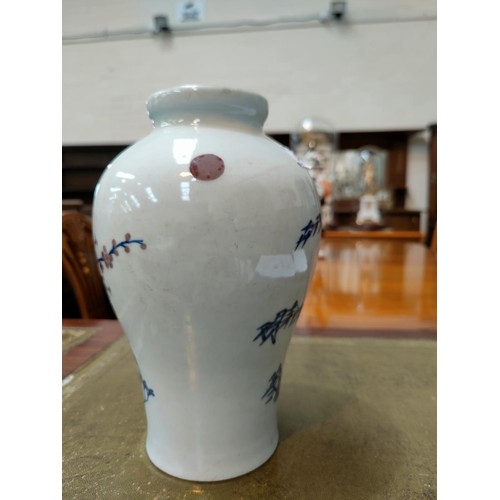 333 - A Chinese blue and white inverted baluster vase depicting trees on landscape with red highlights bea... 