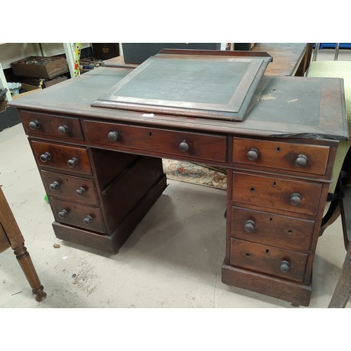 562 - A Victorian mahogany Dickensian style desk with raised slope front writing surface, the kneehole bas... 