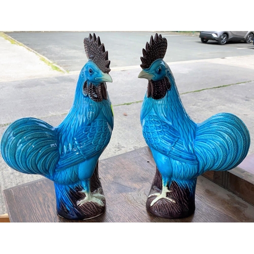 439 - A pair of Chinese cockerills with turquoise and purple glaze, height 31cm (some areas of minor chipp... 