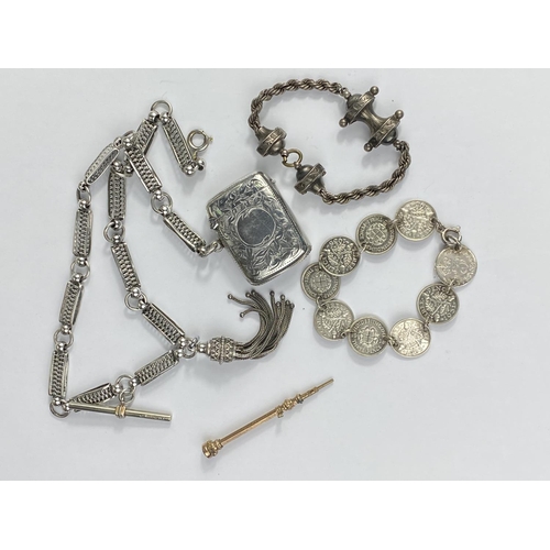 489 - An Edwardian silver vesta case; a white metal fancy link albert watch chain; a silver 3d bracelet; 2... 