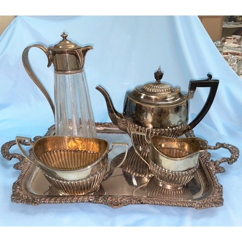 543 - A cut glass claret jug with EPNS mount, a silverplate on copper tray and an EP 3 piece coffee servic... 