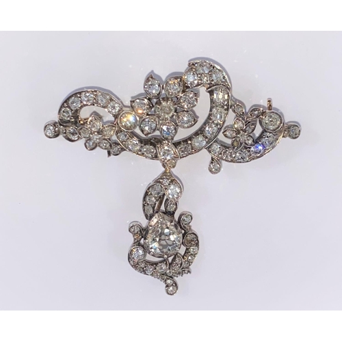 513 - An early 20th century floral and scroll diamond set bar brooch with detachable pendant drop, set 85 ... 
