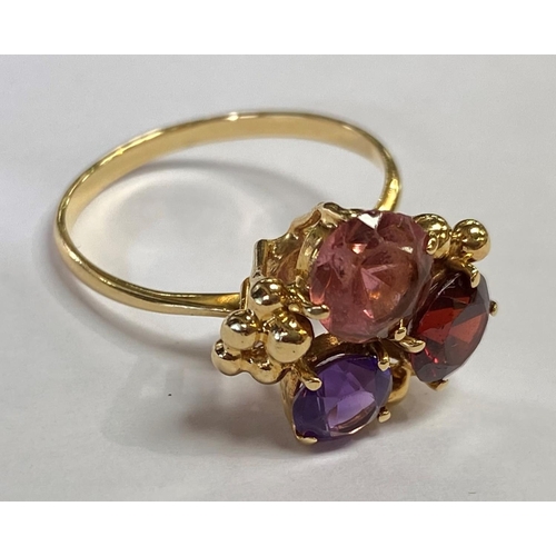 535 - A lady's 18ct hallmarked gold dress ring set with 2 red and 1 orange coloured stone, size O/P 3.2gm ... 