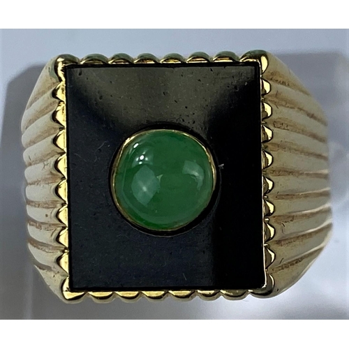 541 - A yellow metal gent's signet ring set with square jet coloured base with central jade coloured domed... 