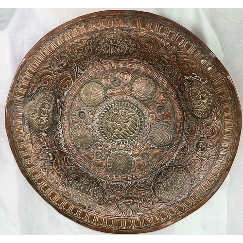 446 - A Tibetan copper and brass charger with relief decoration of buddhas etc, diameter 38cm