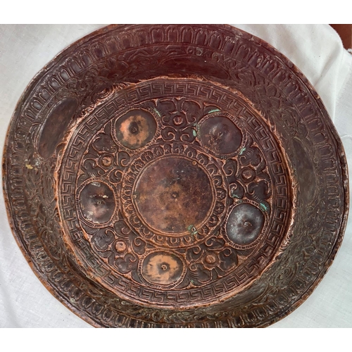 446 - A Tibetan copper and brass charger with relief decoration of buddhas etc, diameter 38cm