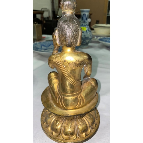 465A - A Chinese gilt bronze figure of a seated buddha in prayer position with leaf mark to base