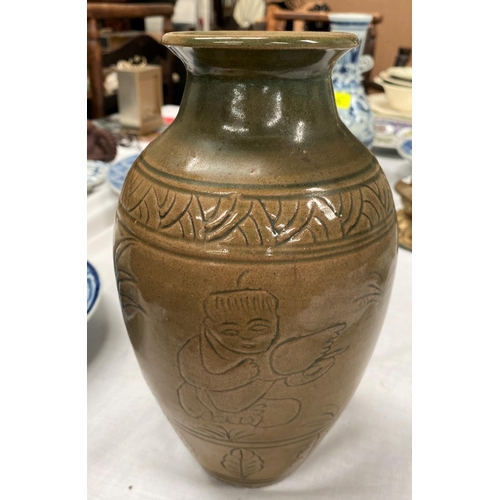 469A - A Chinese stone ware baluster vase with tea dust coloured ground with incised decoration height 23cm