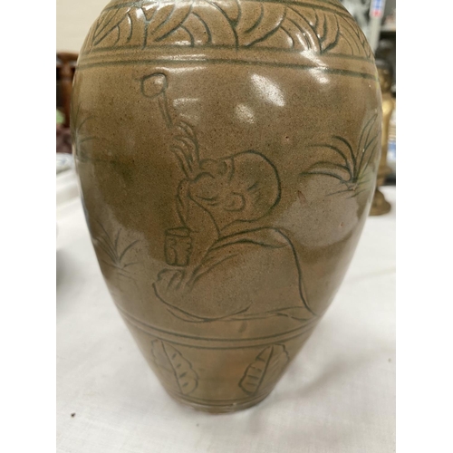 469A - A Chinese stone ware baluster vase with tea dust coloured ground with incised decoration height 23cm