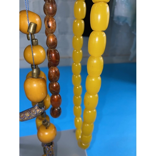 523 - A selection of beads including amber and cherry amber coloured beads etc