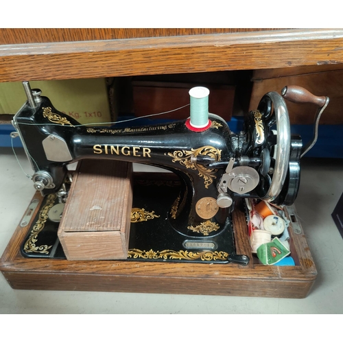 10 - A hand operated sewing machine by Singer; a set of kitchen scales; 3 vintage cameras; cowbells; etc.