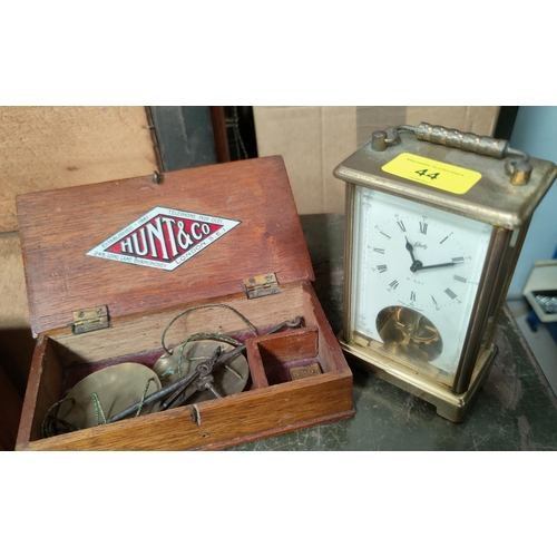 44 - A vintage German 8-day carriage clock and a set of cased apothecary's scales
