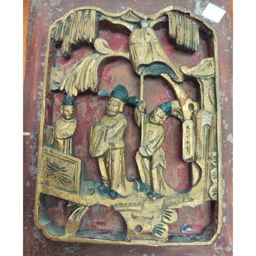 62 - A 19th century Chinese carved wood panel depicting the First Scholar, gilded with red pigment backgr... 