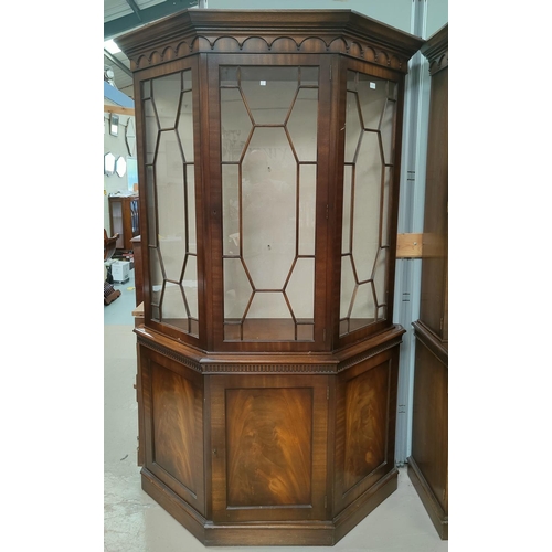 639 - A reproduction canted mahogany full height display cabinet in the manner of 