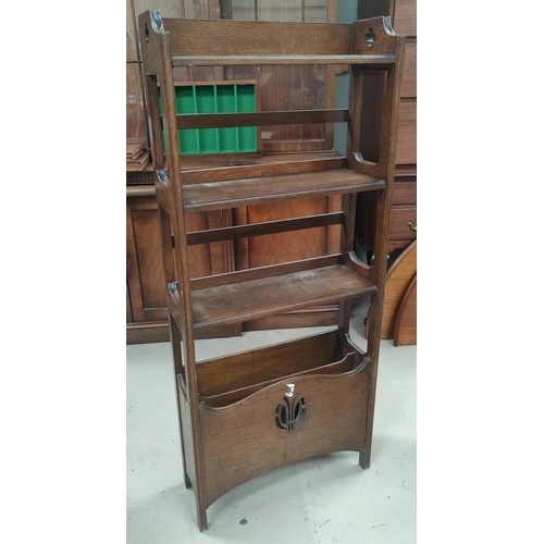 663 - An oak bookcase with magazine rack below in the Arts and Crafts manner. Height 129cm x length 55cm