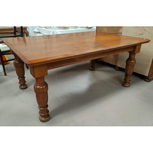 669 - A Golden Oak dining table of rectangular form with rounded edges on heavy turned legs, length 173cm ... 