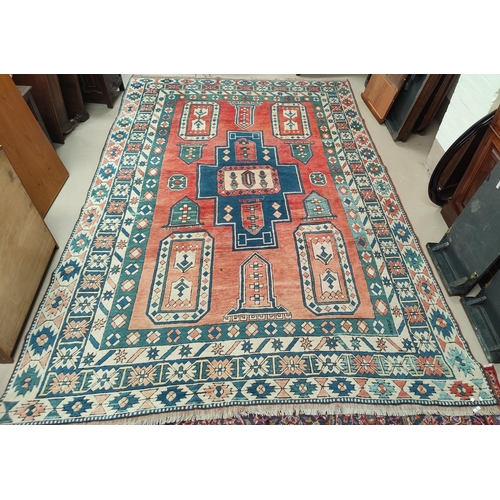 698 - A modern Persian style carpet, hand knotted with geometrical design on a red ground, 350 x 120 cm