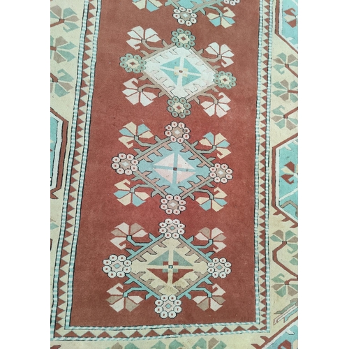 699 - A modern Persian style carpet, hand knotted with geometrical design on a red ground, 360 x 264 cm